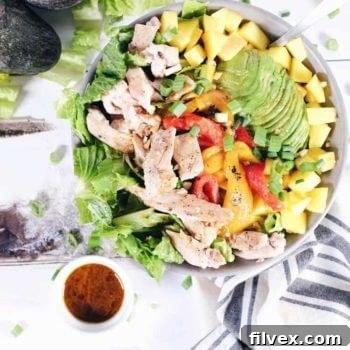 A single serving of chili lime chicken salad in a white bowl, ready to eat.